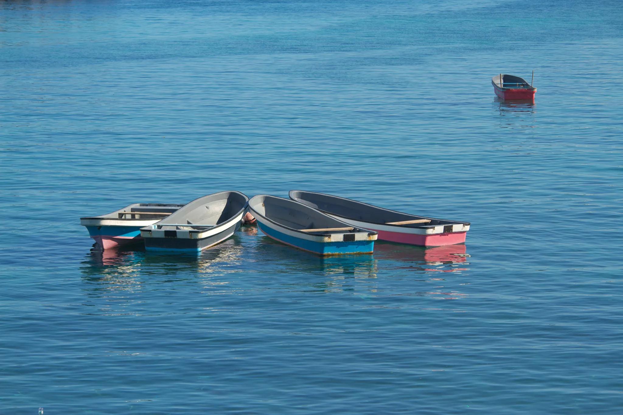 View of the 5 small boats in the blue waters of Moroni harbour, Comoros/ Credit: Antony Velikagathu via Shutterstock